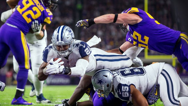 Dallas Cowboys running back Ezekiel Elliott (21) scores a touchdown in the second quarter against the Minnesota Vikings at U.S. Bank Stadium.