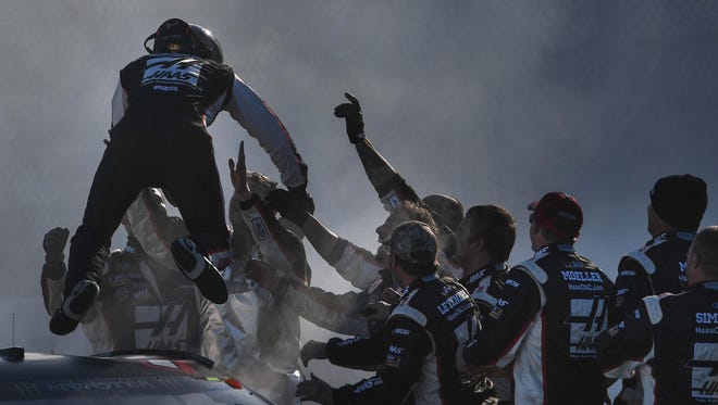 Clint Bowyer gets mobbed by his Stewart-Haas Racing crew after driving to victory at Martinsville Speedway on March 26, 2018 and snapping a long winless streak.