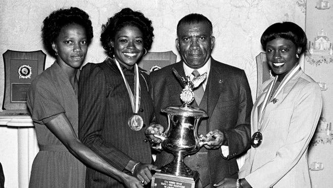 Tigerbelles Helen Berry, left, Kathy McMillan, Coach Ed Temple, and Chandra Cheeseborough show off the National Indoor track and field championship trophy they won last February at the team annual banquet at Two Rivers Mansion Oct. 7, 1980.
