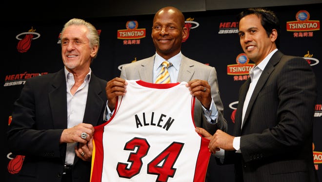 Miami Heat president Pat Riley, left, guard Ray Allen, center, and head coach Erik Spoelstra, right hold up Allen's jersey after Allen signed a contract with the Heat, Wednesday, July 11, 2012.
