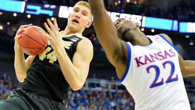 Purdue center Isaac Haas  controls the ball against Kansas forward Dwight Coleby during Sweet 16 play.