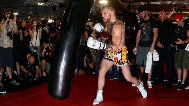 Conor McGregor hits a heavy bag during a media workout in preparation for his fight against Floyd Mayweather at UFC Performance Institute.