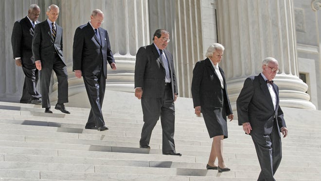Supreme Court justices precede the casket of Chief Justice William Rehnquist down the steps of the Supreme Court on Sept. 7, 2005.