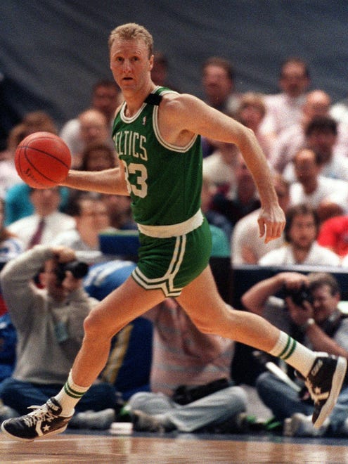 Boston Celtics' Larry Bird brings the ball up the court against the Indiana Pacers on March 27, 1990, in Indianapolis.