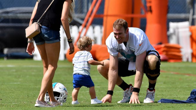 Miami Dolphins quarterback Ryan Tannehill (17) greets his son Steel, and his wife Lauren Tannehill after practice drills at Baptist Health Training Facility at Nova Southeastern University.