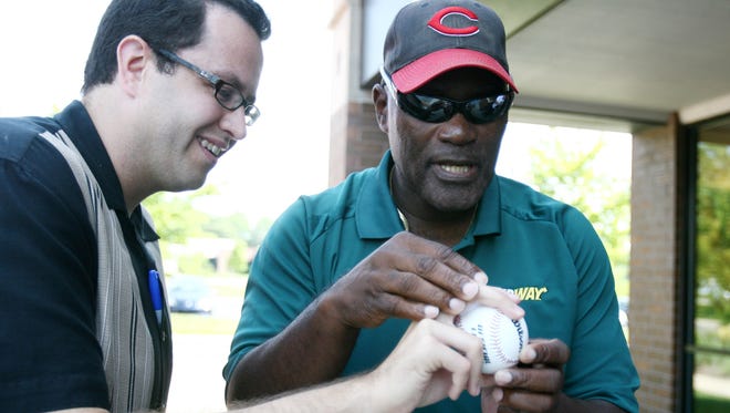 MLB Hall of Famer George Foster (right) gives Jared Fogle, the Subway guy, some expert advice on how to hold and throw a baseball at a Subway in Carmel Friday, June 26, 2009.