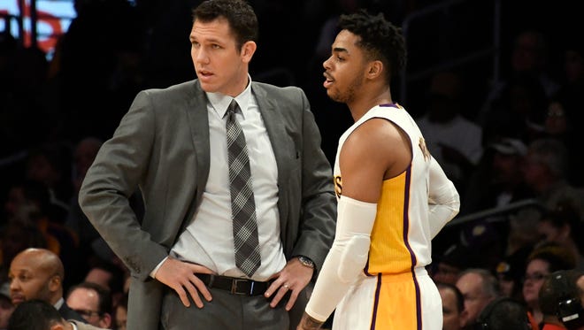 Los Angeles Lakers head coach Luke Walton talks with guard D'Angelo Russell (1) in the first quarter against the San Antonio Spurs at Staples Center.