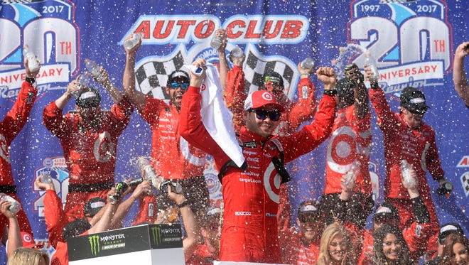 Kyle Larson celebrates after winning Sunday's Auto Club 400.
