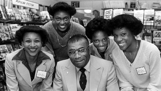 Tennessee State track coach Ed Temple, front center, is surrounded by the Tigerbelles who recently broke the world's record in the mile relay, Debbie Jones, left, Chandra Cheeseborough, Helen Blake and Ernestine Davis. The group was at Mill's Bookstore Feb. 14, 1980 for Temple's book signing of his new book, "Only the Pure in Heart Survive."