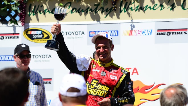 Clint Bowyer raises a glass of wine after winning the Toyota/Save Mart 350 at Sonoma Raceway, one of three races Bowyer won in 2012.
