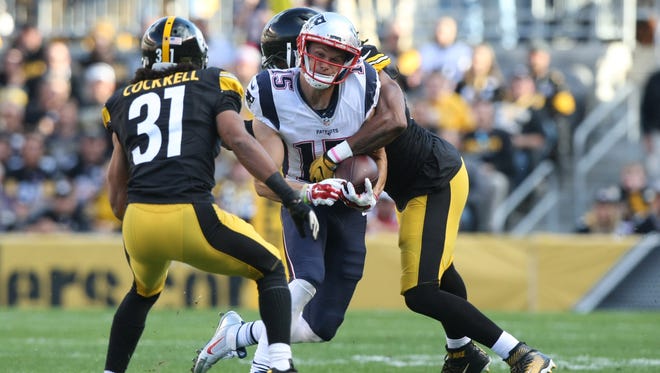 Pittsburgh Steelers linebacker Jarvis Jones forces a fumble as he hits New England Patriots wide receiver Chris Hogan during the first quarter.
