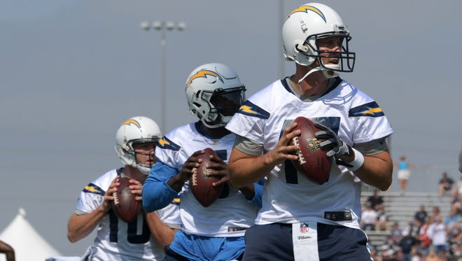 Los Angeles Chargers quarterbacks Philip Rivers (17), Cardale Jones (5) and Kellen Clemens (10) throw the football during the opening day of training camp at the Jack Hammett Sports Complex.