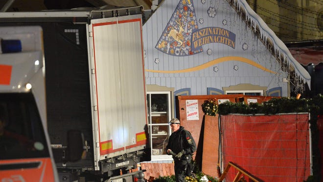 A police officer inspects the truck that crashed into a christmas market in Berlin, on Dec. 19, 2016.