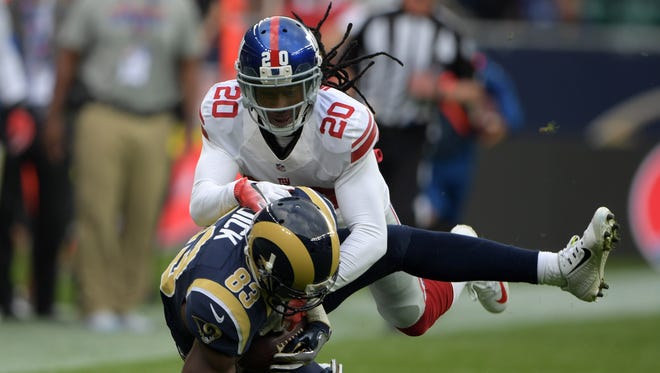 Los Angeles Rams wide receiver Brian Quick (83) is tackled by New York Giants cornerback Janoris Jenkins (20) during game 16 of the NFL International Series at Twickenham Stadium.