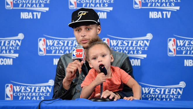 2015: Stephen Curry and Riley Curry address the media in a press conference after Game 5 of the Western Conference Finals.