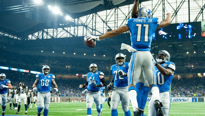 Detroit Lions wide receiver Marvin Jones (11) celebrates his touchdown with teammates during the first quarter against the Los Angeles Rams at Ford Field.