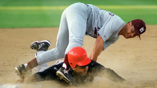 Rep. Jesse Jackson, Jr., D-Ill., bottom, is out as he tries to steal third base, tagged out by Rep. Chip Pickering, R-Miss., in the 36th annual congressional baseball game at Prince George's Stadium in Bowie, Md., on July 29, 1997.