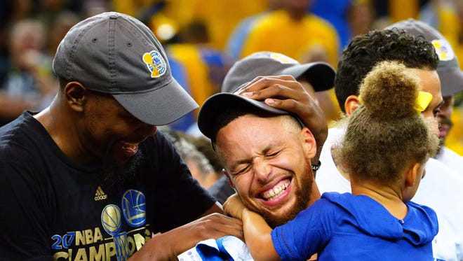 2017: Kevin Durant and Curry celebrate with his daughter Riley after winning the NBA championship.