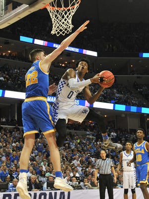 Kentucky Wildcats guard De'Aaron Fox flies to the hoop against UCLA Bruins forward TJ Leaf.