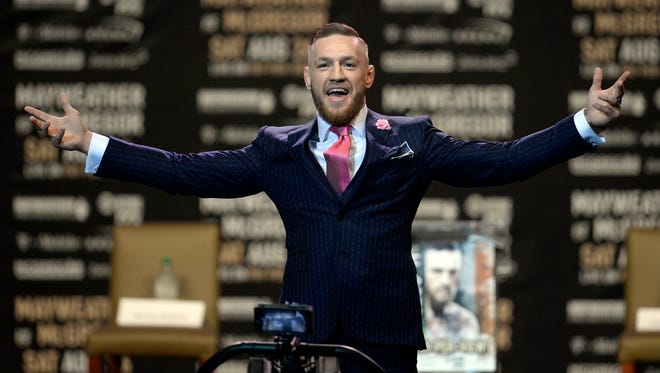 Conor McGregor arrives on stage before the world tour press conference to promote the upcoming Mayweather vs McGregor boxing match.