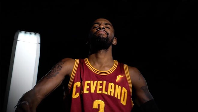 The Cavs' Kyrie Irving shows off the Goodyear logo on the team's jerseys.