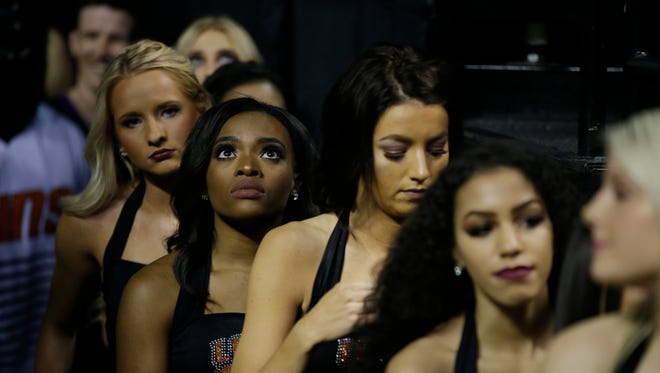 Phoenix Suns cheerleaders stand by before the start of a regular-season NBA basketball game with the Dallas Mavericks in Mexico City, Thursday, Jan. 12, 2017.