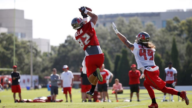 Buccaneers tight end Antony Auclair (82) makes a catch behind linebacker Riley Bullough (49) during practice in Tampa Bay.