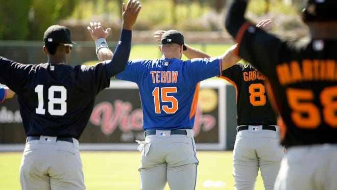Oct. 11: Tim Tebow warms up for his Fall League debut.