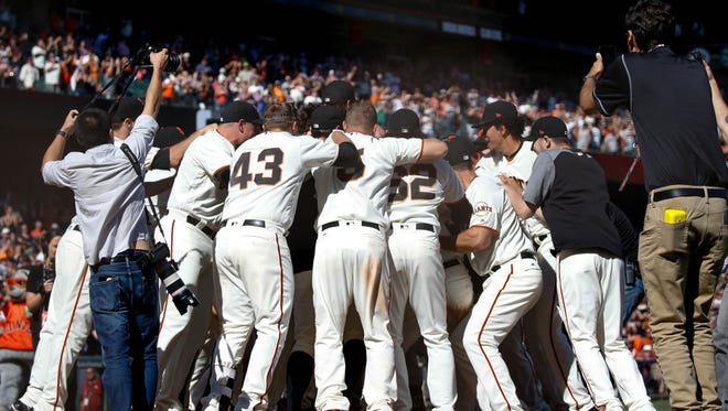 Oct. 1: Giants players celebrate after defeating the Padres on a walk-off homer by Pablo Sandoval.
