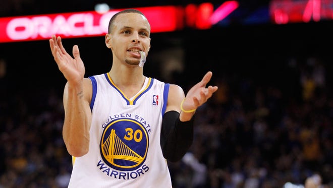 2014: Stephen Curry reacts after the Warriors make a three-point basket.