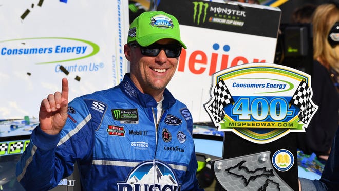 Kevin Harvick celebrates with the Consumers Energy 400 trophy at Michigan International Speedway after recording his seventh win of 2018 on Aug. 12.