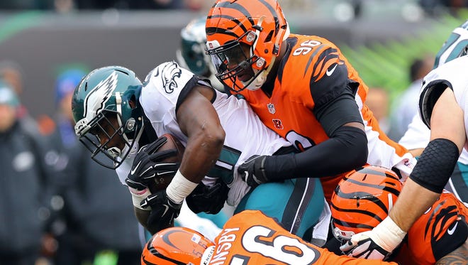 Philadelphia Eagles running back Wendell Smallwood (28) is tackled by Cincinnati Bengals defensive end Carlos Dunlap (96) in the first half at Paul Brown Stadium.