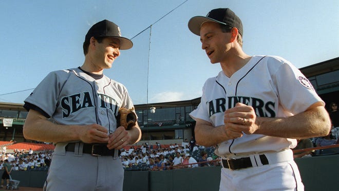 Rep. Rick White, R-Wash, left, discusses batting stances and swings with Rep. Adam Smith, D-Wash, before the 36th annual congressional baseball game at Prince George's Stadium in Bowie, Md., on July 29, 1997.