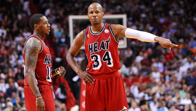 Ray Allen (right) talks with point guard Mario Chalmers (left) during the first half against the Charlotte Bobcats at American Airlines Arena.
