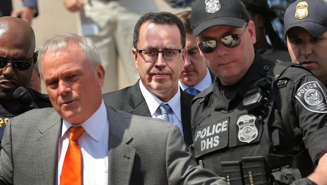 Jared Fogle, a former pitchman for Subway, is escorted to a car by police after pleading guilty on Wednesday, Aug. 19, 2015, to charges of child pornography and having sex with minors, according to court documents. Fogle will be sentenced Thursday, Nov. 19, 2015.