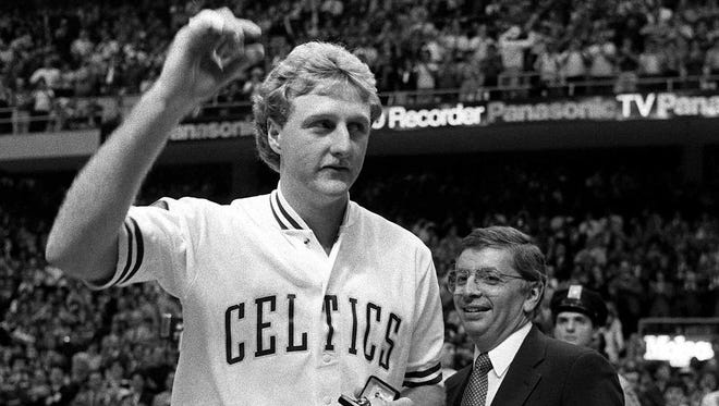 Boston Celtics' Larry Bird, left, holds his NBA Championship Ring on  Oct. 31,1984 at Boston Garden.
