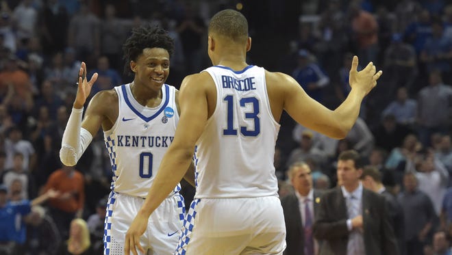 Kentucky's De'Aaron Fox, left, and Isaiah Briscoe, right, celebrate after the Wildcats defeated UCLA in the Sweet 16 of the NCAA tournament at FedExForum in Memphis.