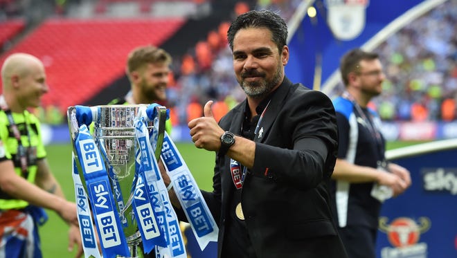 Coach David Wagner holds the Championship Playoff trophy after Huddersfield Town won the penalty shootout in the English Championship playoff.