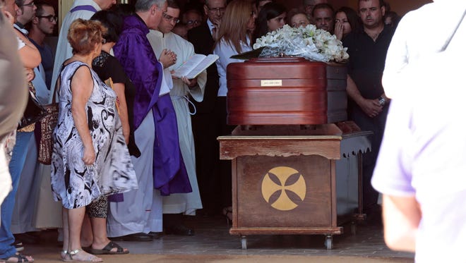 Relatives and friends of 75-year-old Pepita Codina attend her funeral in Sant Hipolit de Voltrega, Barcelona, Spain on Aug. 22, 2017.