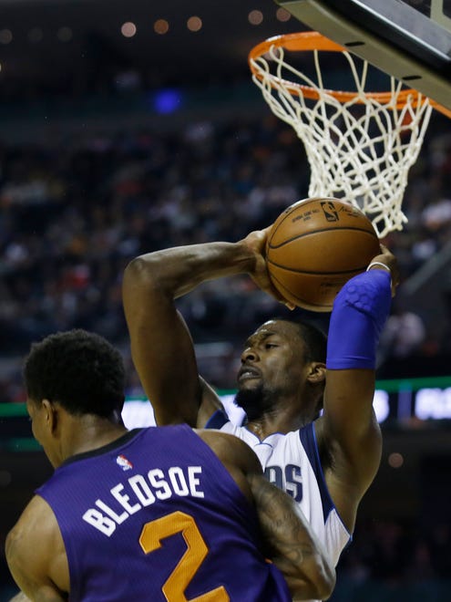 Dallas Mavericks Harrison Barnes holds on to the ball behind Phoenix Suns Eric Bledsoe in the first half of their regular-season NBA basketball game in Mexico City, Thursday, Jan. 12, 2017.