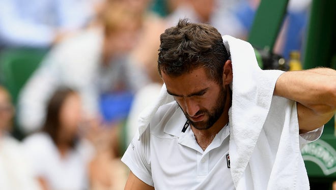 Marin Cilic takes a break during his match against Roger Federer.