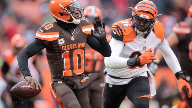 Cincinnati Bengals defensive end Carlos Dunlap (96) chases Cleveland Browns quarterback Robert Griffin III (10) out of the pocket in the fourth quarter during the Week 14 NFL game between the Cincinnati Bengals and the Cleveland Browns, Sunday, Dec. 11, 2016, at FirstEnergy Stadium in Cleveland. Cincinnati won 23-10.