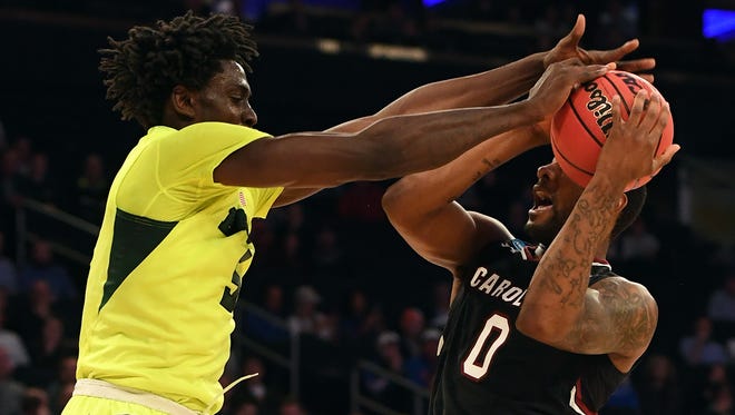 Baylor forward Johnathan Motley, left, blocks a shot by South Carolina guard Sindarius Thornwell, right, during the first half of their game in the Sweet 16 of the NCAA tournament at Madison Square Garden in New York.