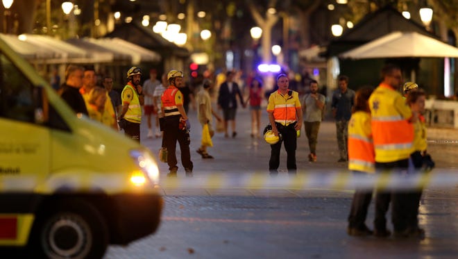 Emergency workers stand on a blocked street in Barcelona.