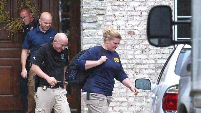 Two FBI agents (front) exit the Zionsville home of Subway spokesperson Jared Fogle in the 4500 block of Woods Edge Drive in Zionsville during a morning-long investigation in FogleÕs home in the Austin Oaks subdivision on Tuesday morning, July 7, 2015. FogleÕs attorney says Fogle is cooperating in the probe and has not been detained or arrested. Russell Taylor, 43, who had been the Jared Foundation executive director, faces federal charges after being arrested in late April on seven counts of production of child pornography and one count of possession of child pornography.