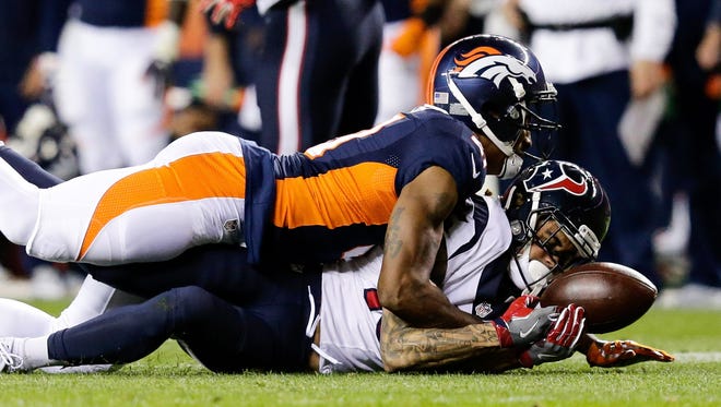 Broncos defender Aqib Talib (21) breaks up a first-half pass intended for Texans receiver Will Fuller (15).