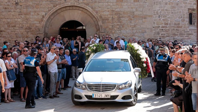 A hearse with the remains of a 65-year-old man and his 3-year-old grandson arrives at Sant Pere church during their funeral in Rubi, Spain on Aug. 21, 2017.
