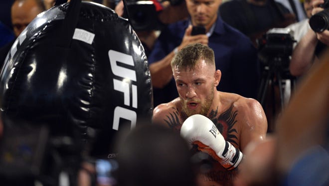 Conor McGregor hits an uppercut bag during a media workout in preparation for his fight against Floyd Mayweather at UFC Performance Institute.