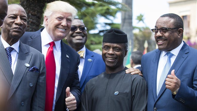 From left, Guinea's President Alpha Conde, U.S. President Donald Trump, President of the African Development Bank Akinwumi Adesina, Nigeria's Vice President Yemi Osinbajo and Ethiopia's Prime Minister Hailemariam Desalegn pose for a group photo on the second day of the G7 Summit at the San Domenico in Taormina, Sicily, Italy, on May 27, 2017.