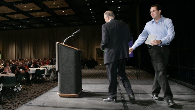 Master of ceremonies Jared Fogle (right), with the Governor's Council for Physical Fitness and Sports, walks off the stage at the Indiana Convention Center after introducing speaker Jim McClelland (left), president of Goodwill Industries of Central Indiana, at the second INShape Indiana Health Summit on Monday, Nov. 27, 2006.